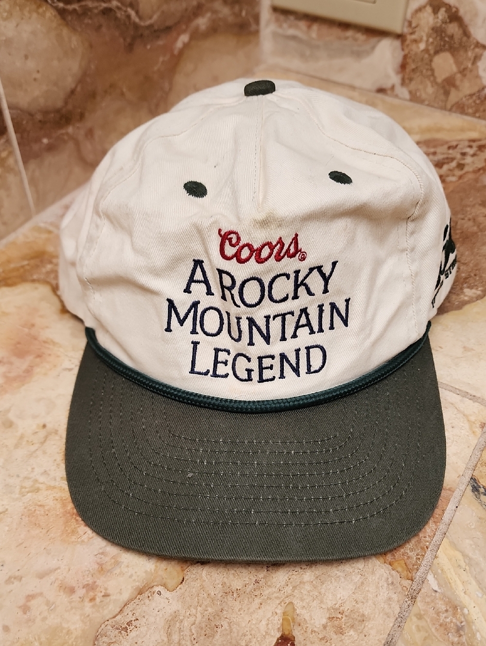 A Rocky Mountain Legend White and Dark Green Baseball Cap